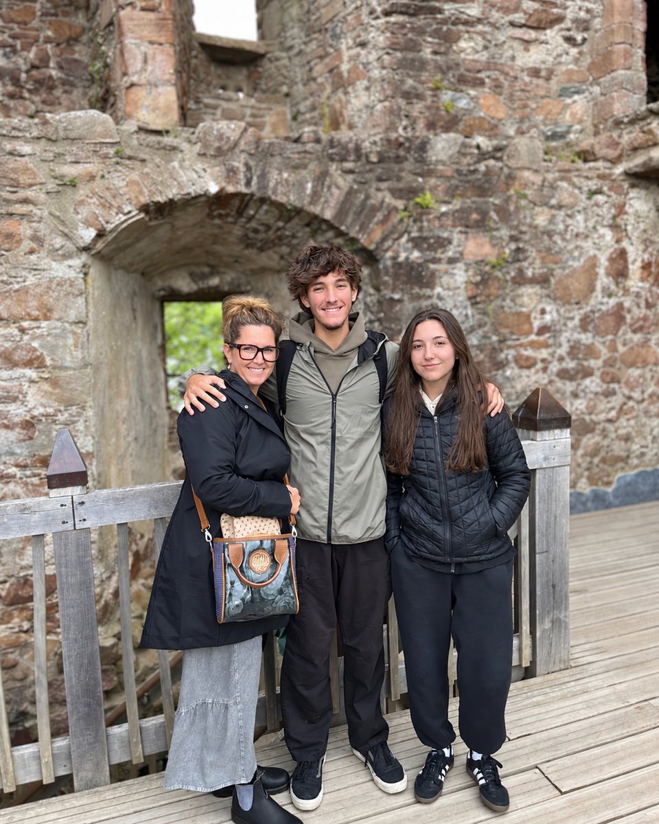 Tim's wife, son and daughter standing inside the stone walls of Urquhart Castle